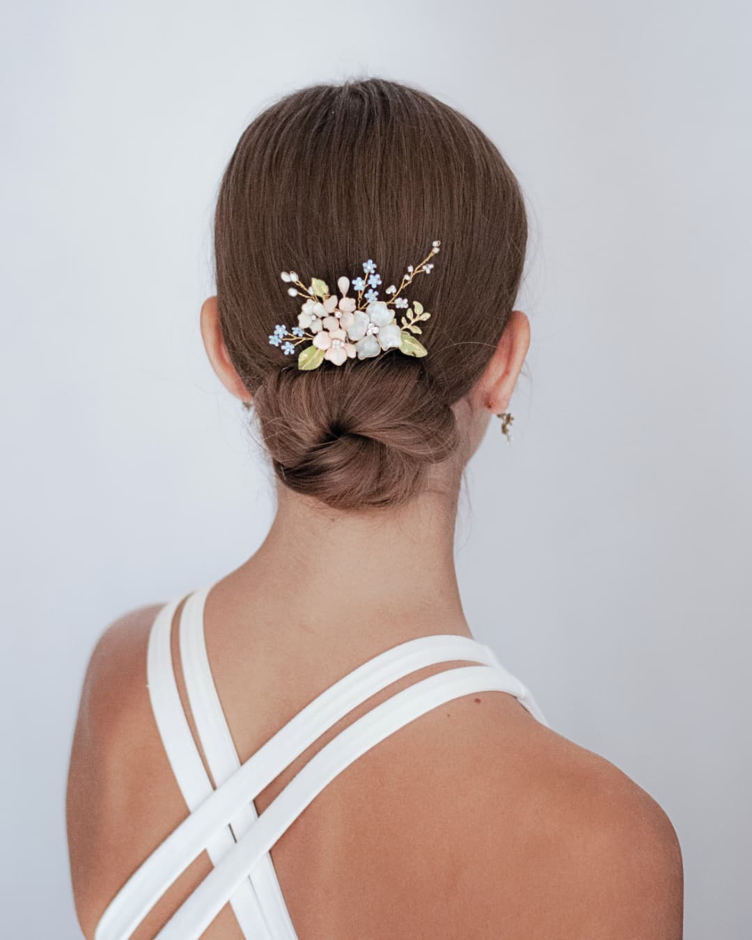 Fermaglio gioiello artigianale per acconciatura sposa boho-chic con bouquet di fiori smaltati a mano.