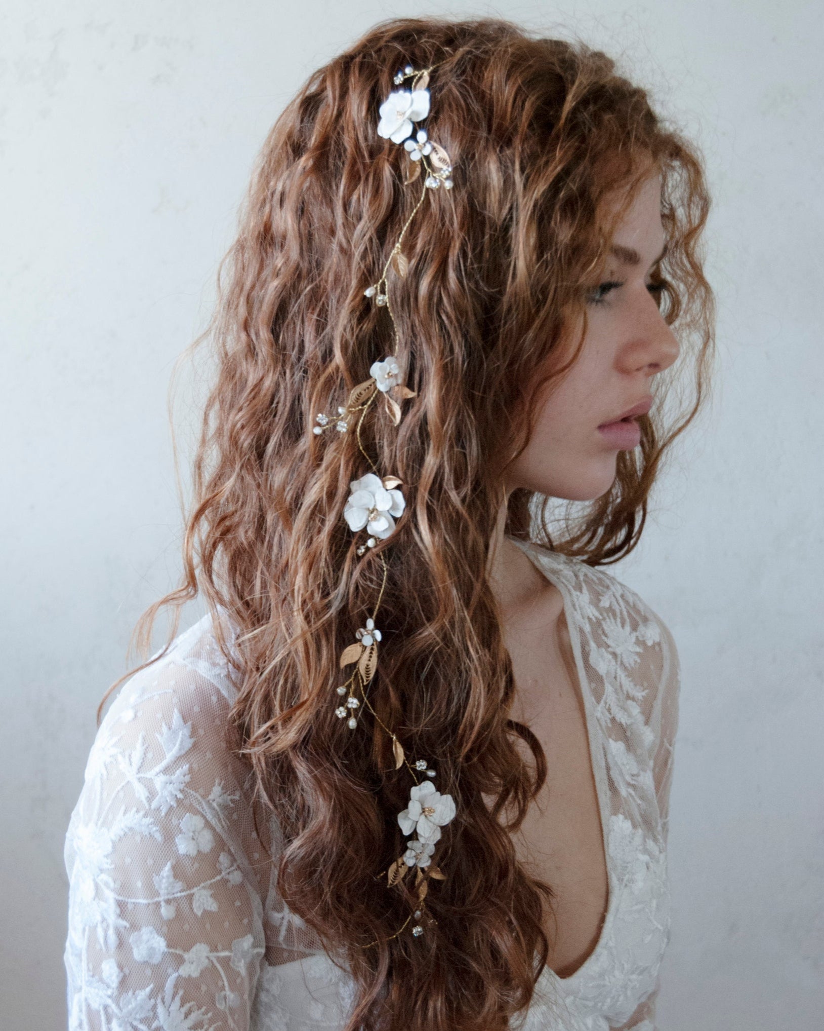 Filo gioiello decorato con fiori e foglie dorate, perfetto per una sposa moderna.