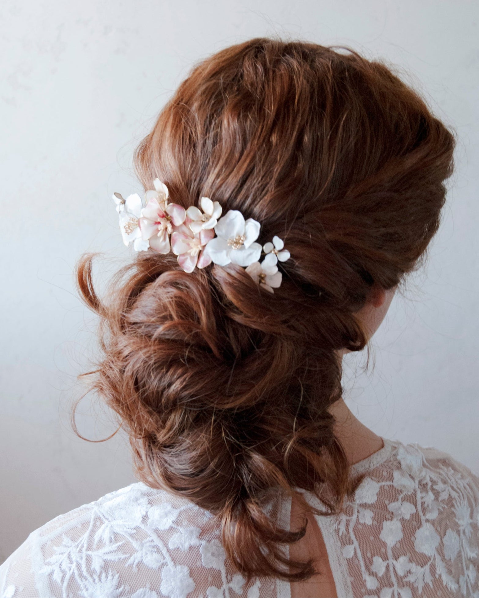 Pettinino da sposa con fiori bianchi e rosa cipria, ideale per un look naturale e chic.