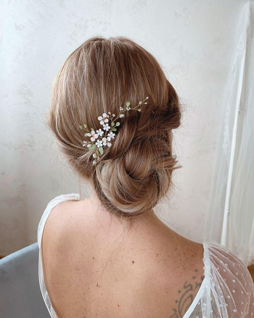 Forcina gioiello Ramilla indossata su un raccolto morbido per un look sposa elegante e asimmetrico.