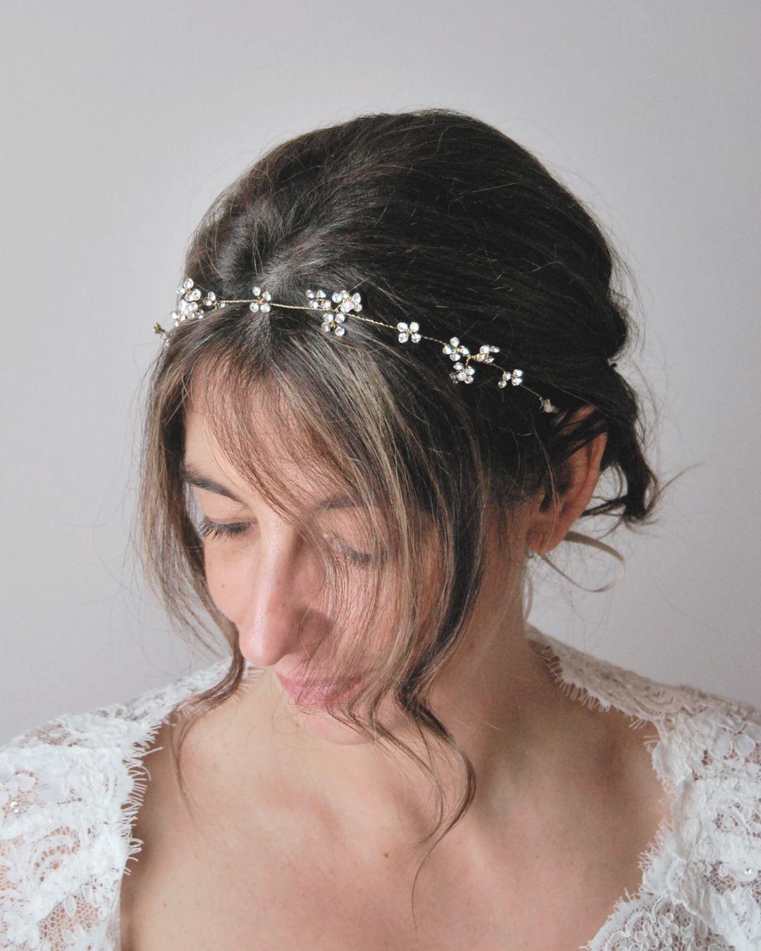 Coroncina Brillaflora su chignon sposa vista tre quarti, fiorellini di cristalli Swarovski su filo oro - Elibre