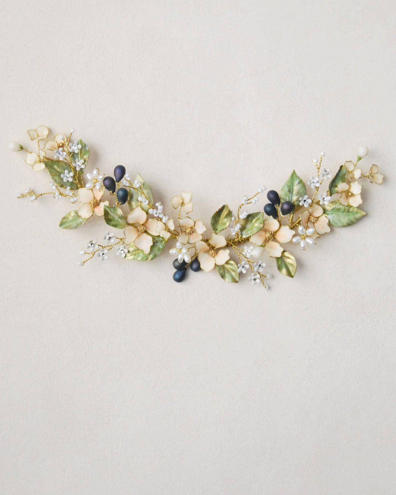 Accessorio boho chic con fiori delicati, perfetto per un raccolto morbido dal tocco botanico.