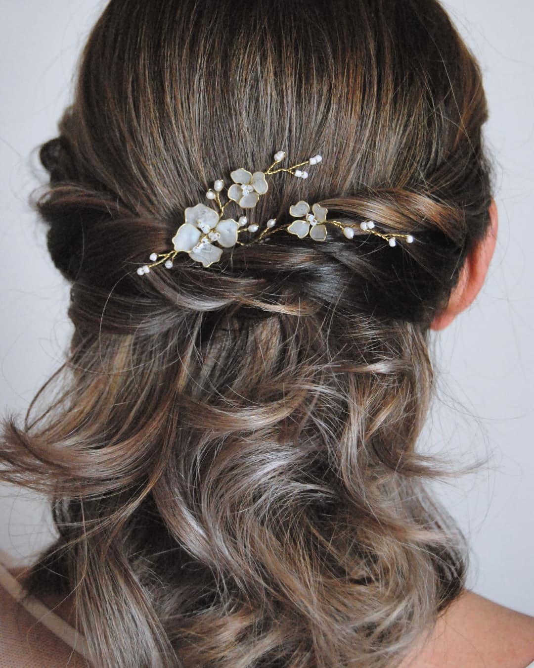 Forcina sposa Elibre con fiori bianchi satinati semitrasparenti e cristalli luminosi.