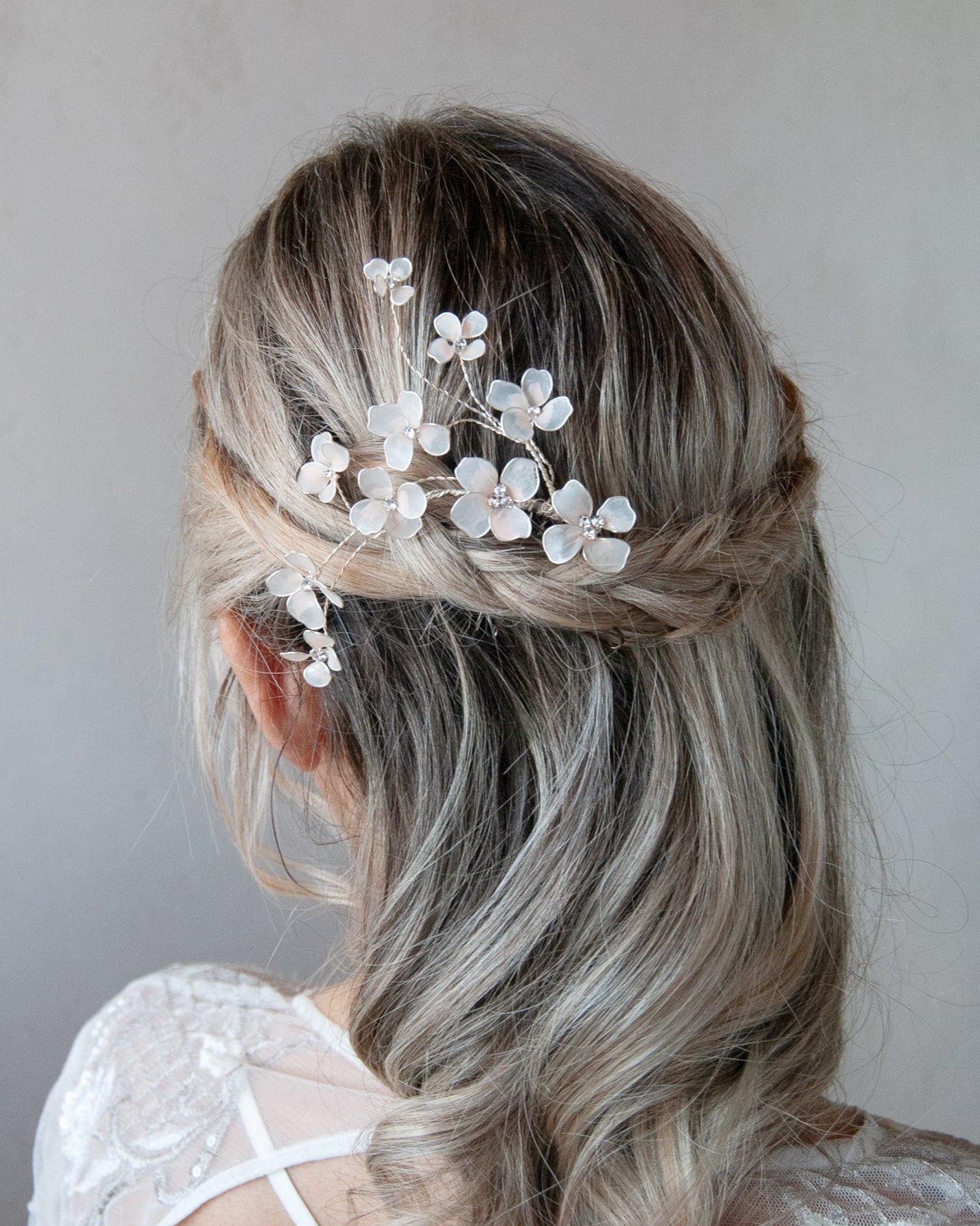 Accessorio per capelli con fiori rosa e rami, perfetto per un look elegante e chic.