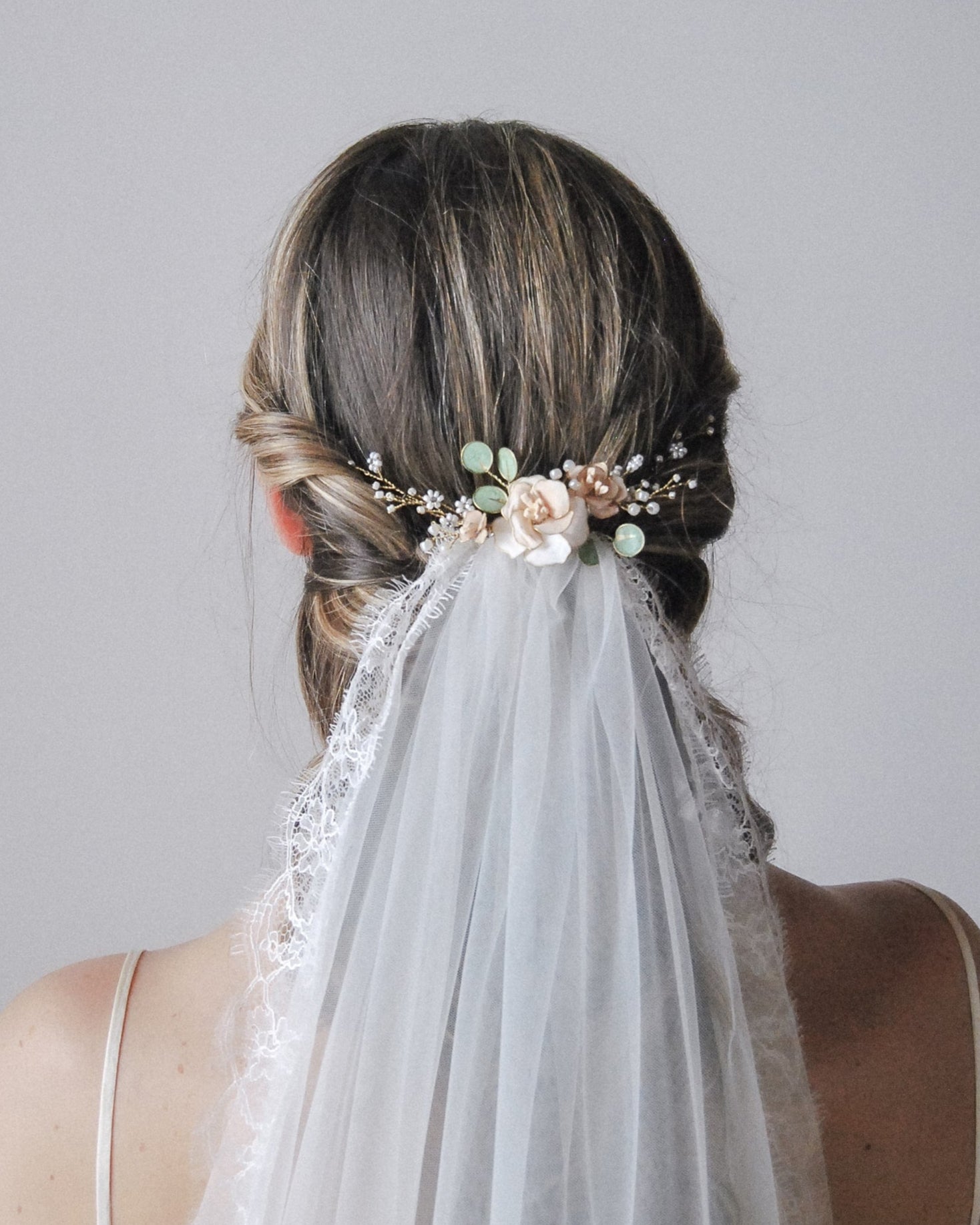 Accessorio country chic con fiori delicati e foglie naturali, per acconciature semplici e armoniose.